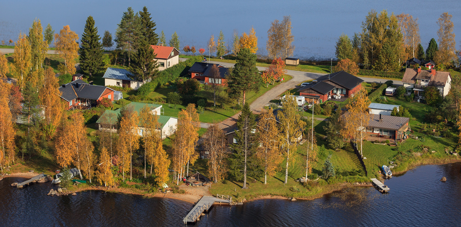 Kuva pienestä saaresta, jossa on taloja ja puita.